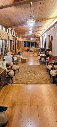 a large living room with wooden floors and furniture at Milntown Kaynes in Wellington Town