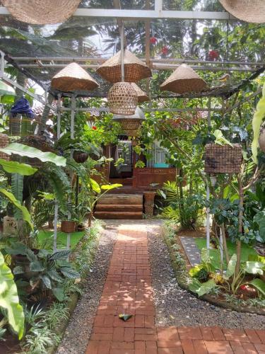 a greenhouse filled with lots of plants at Buratwangi Joglo House in Kerobokan