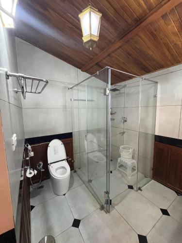 a bathroom with a toilet and a glass shower at Milntown Kaynes in Wellington Town