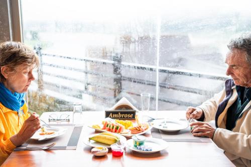 two older women sitting at a table eating food at Baron Luxury Boutique in Nuwara Eliya