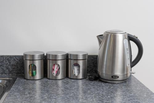 three trash cans sitting on top of a kitchen counter at Grove Park Motor Lodge in Blenheim