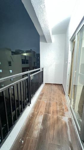 a balcony of a building with a wooden floor at Abode Stayz Madhapur in Hyderabad