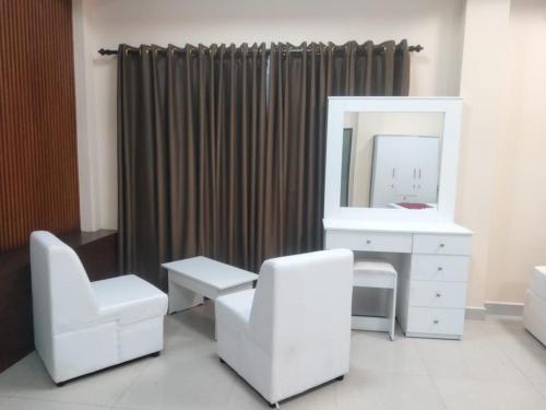 a bathroom with a white vanity and a mirror at Gnaanams Hotel and Restaurant in Jaffna