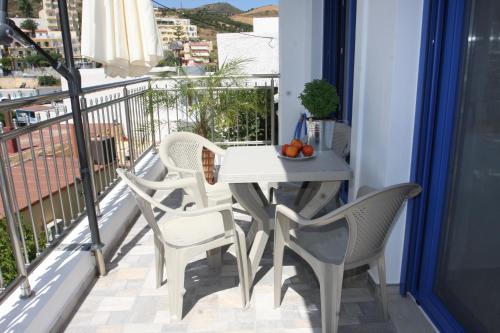 balcone con tavolo e sedie. di SunOrama Apts-Studios a Balíon