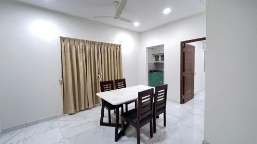 a dining room with a table and chairs at Abode Stayz Madhapur in Hyderabad