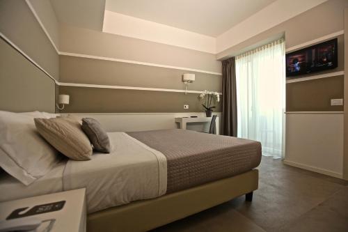 Ένα ή περισσότερα κρεβάτια σε δωμάτιο στο Hotel Ambassador
