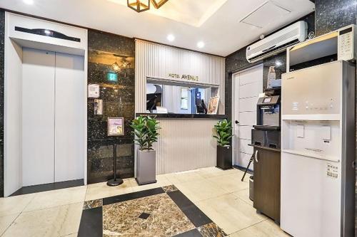 a room with a office with a counter and plants at Suwon Hotel Avenue in Hagwanggyo-dong