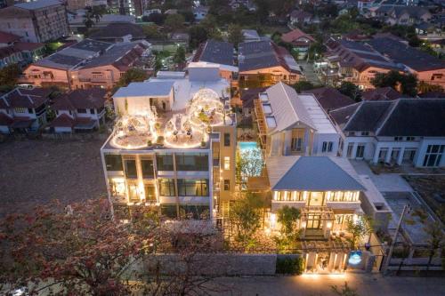 an aerial view of a large house with lights at SHAN Villas Sukhumvit in Bangkok