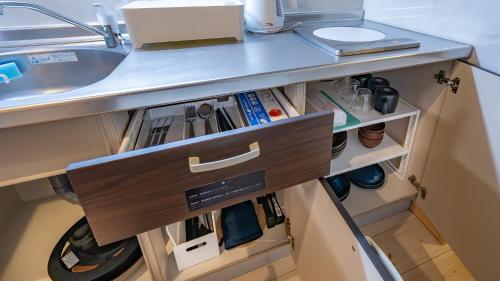 a kitchen with a sink and a counter with a drawer at Stay Maison Hida Takayama in Takayama