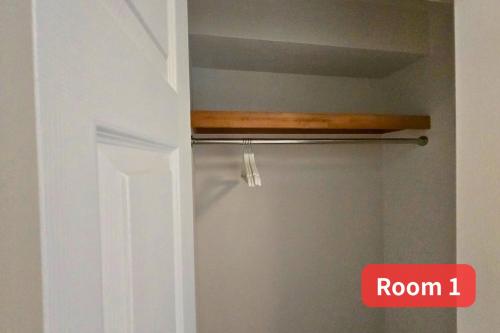 a room with a closet with a door and a shelf at Vacation House 2 in Funabashi