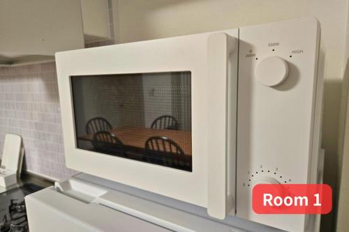 a microwave with a wooden table inside of it at Vacation House 2 in Funabashi