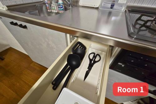 a drawer in a kitchen with scissors in it at Vacation House 2 in Funabashi