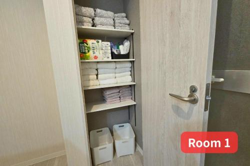 a door open to a bathroom with a toilet and towels at Vacation House 2 in Funabashi