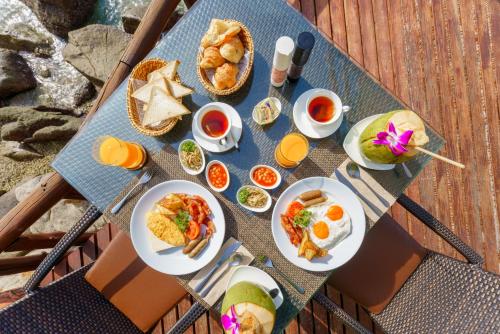 a table topped with plates of food and drinks at View Point Resort in Koh Tao