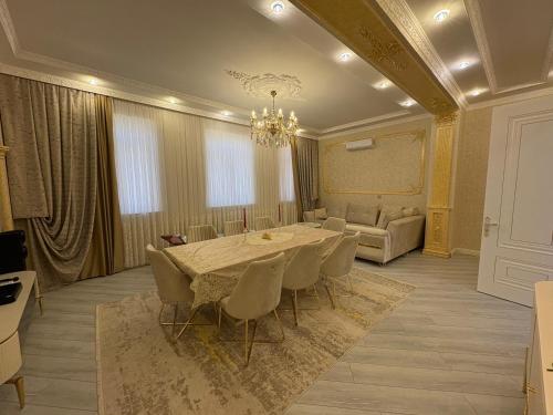 a dining room with a table and chairs and a couch at nearby Airport Apartment in Bina