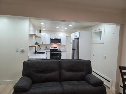 a living room with a couch and a kitchen at 2bdrm Fairbanks Apt Great Location in Fairbanks