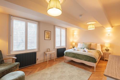 a bedroom with a bed and two windows at Central Whitchurch - Lowcross House Guest Bedroom 3 in Whitchurch