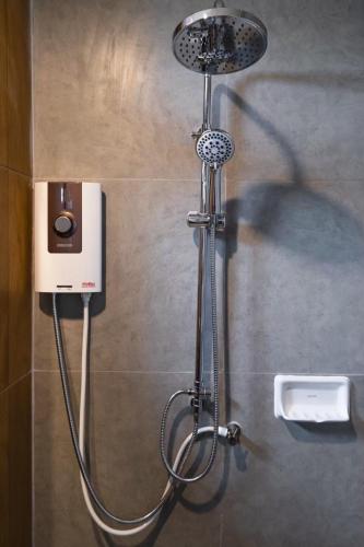 a shower in a bathroom with a shower head at U- Homehotel Nakhonpanom in Nakhon Phanom