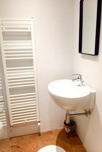 a white bathroom with a sink and a mirror at VILLA VINICIA, pool, jacuzzi, airco in Domaso