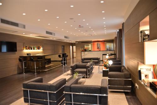 a salon with black chairs and a barber shop at Hotel Forum in Baranzate