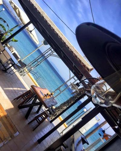 a view of the beach and the ocean from a table at Sydney Hotel in Kefalos