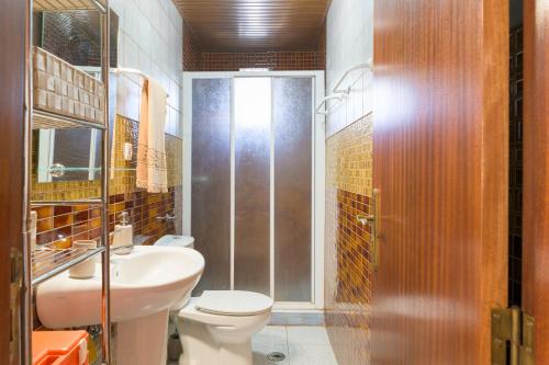 a bathroom with a toilet and a sink and a shower at Costa Vicentina in Cercal