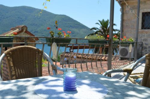 a glass of water sitting on top of a table at Apartments Franovic in Perast