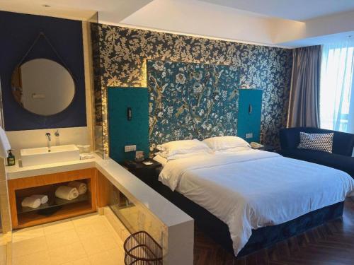 a bedroom with a bed and a sink and a mirror at Jinjiang Metropolo Hotel - Taizhou Wanda Plaza in Taizhou