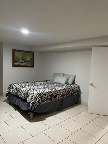 a bedroom with a zebra print bed in a room at Ocean front apartment. in San Antonio del Mar