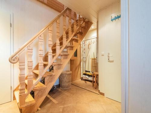 a wooden staircase in a home with a hallway at Cozy Forest Hideaway in Suhl in Suhl