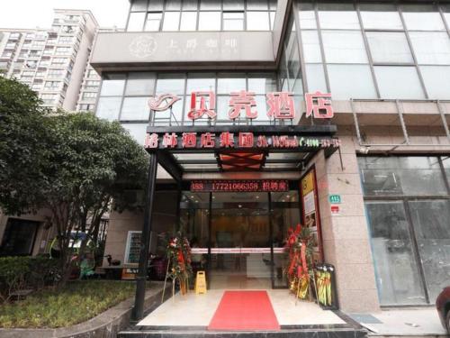 a building with a sign on the front of it at Shell Shanghai Jiading Nanxiang Town Minzhu Street Hotel in Shanghai