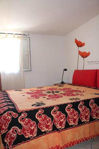 a bedroom with a bed with a dragon blanket at Mansarda 25 in Terracina