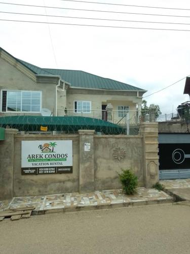 a house with a sign in front of it at Arek Condos Accra in Sotuom