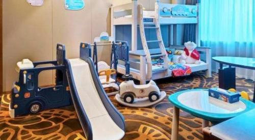 a childs room with a bunk bed and play equipment at Wuhan Gleetour Hotel in Wuhan