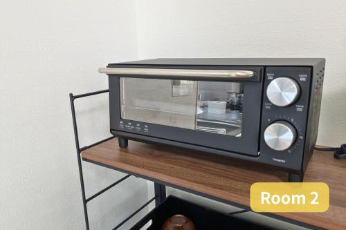 a black toaster oven sitting on top of a table at Vacation House 2 in Funabashi
