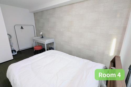a bedroom with a white bed and a desk at Vacation House 2 in Funabashi