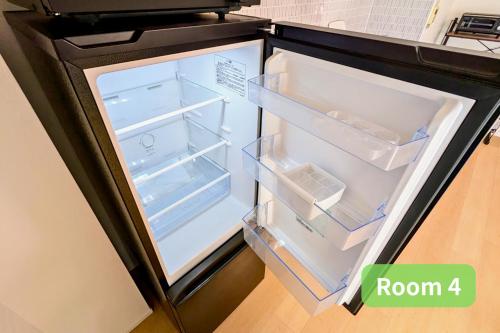 an empty refrigerator with its door open in a kitchen at Vacation House 2 in Funabashi