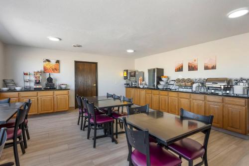 a restaurant with tables and chairs and a kitchen at Quality Inn & Suites Fillmore I-15 in Fillmore