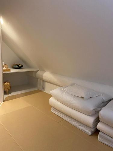 a attic room with a bed and a shelf at V-WIN - Vacation STAY 07301v in Kutchan