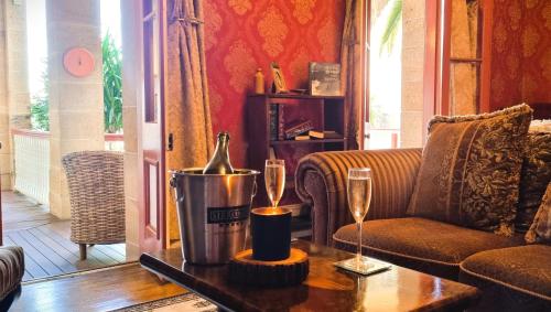 a living room with a couch and a table with champagne glasses at The Abbey in Warwick