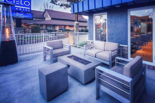 a patio with couches and chairs and a fire pit at Cielo Hotel Bishop-Mammoth, an Ascend Collection Hotel in Bishop