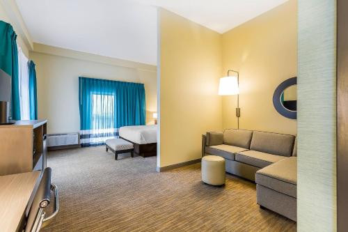 a hotel room with a couch and a bed at Marina Bay Hotel & Suites, an Ascend Collection Hotel in Chincoteague