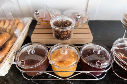 a bunch of food in plastic containers on a table at Sigalas Beach Hotel in Kamari