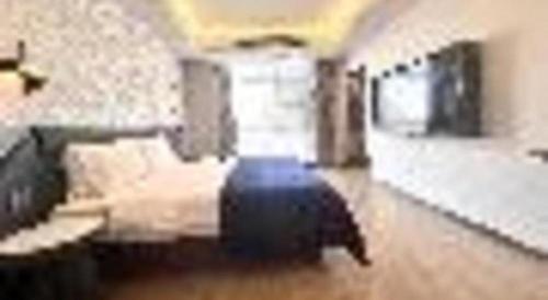 a living room with a couch and a room with a unintention at Yitel Collection Lianyungang High-speed Railway Station Suning Plaza in Lianyungang