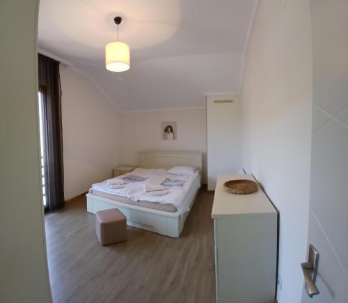 a white room with a bed and a table at Omsi Villa with views in Mtskheta