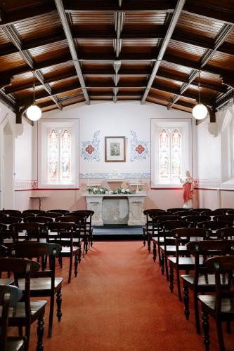 a room with rows of chairs in a church at The Abbey in Warwick