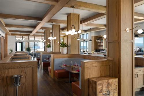 a restaurant with wooden walls and tables and chairs at Hotel Avail Rogers, Tapestry Collection By Hilton in Rogers