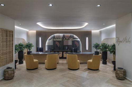 a lobby with chairs and a table and a sign at Zemi Miches Punta Cana All-Inclusive Resort, Curio by Hilton in Miches