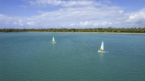 two boats in a large body of water at Zemi Miches Punta Cana All-Inclusive Resort, Curio by Hilton in Miches