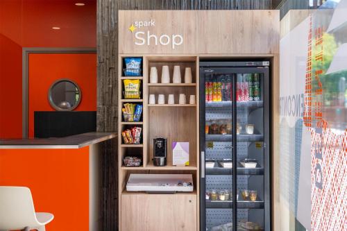 a store with a soft drink cooler in a store at Spark by Hilton Lyon Park Saone in Lyon
